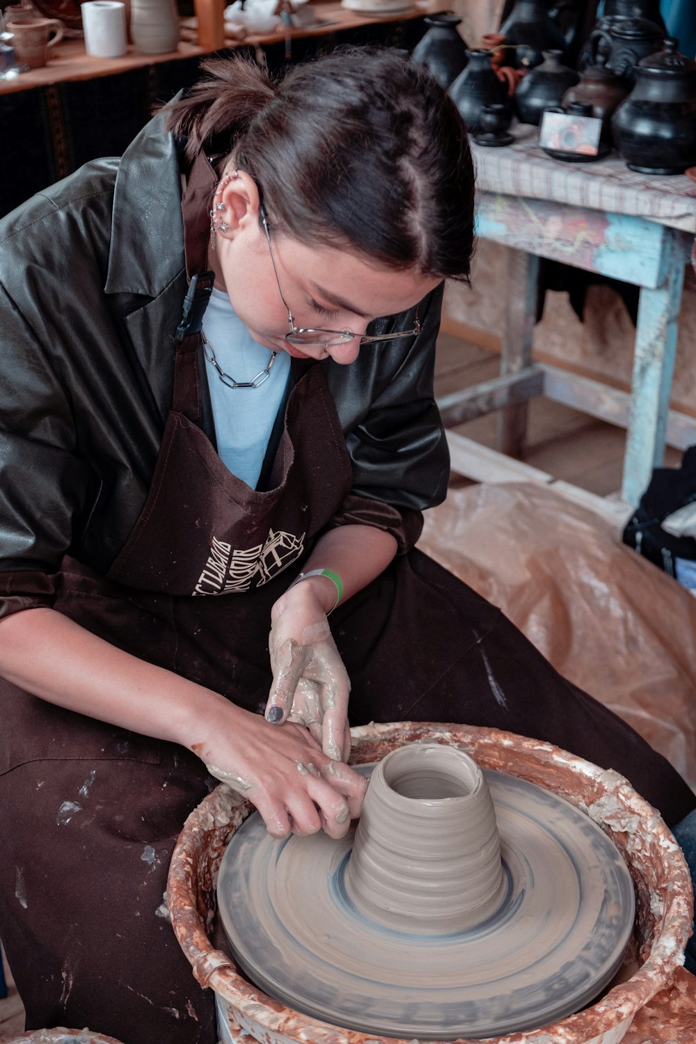 A clay piece being formed before drying and firing — temporary reference photograph